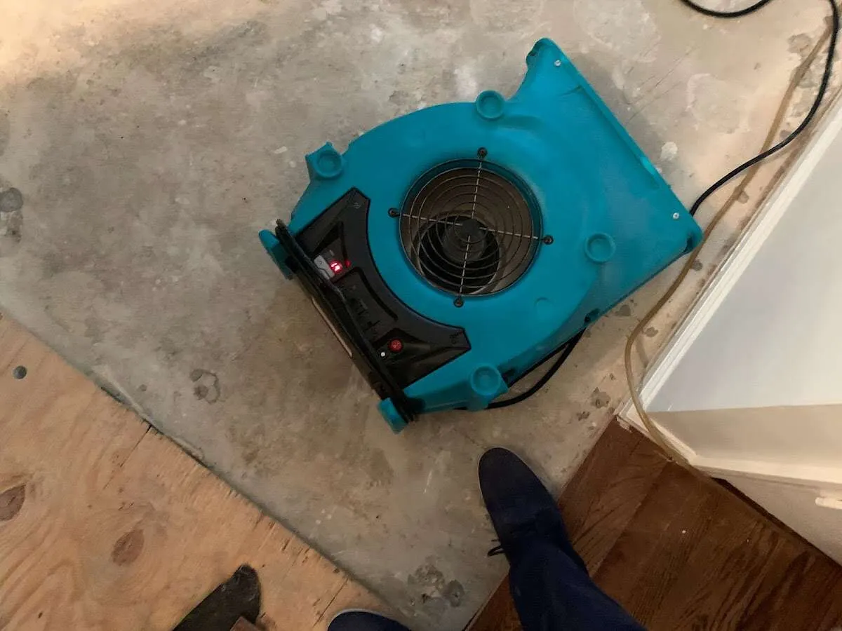 Air mover drying subfloor during Leak Detection & Repair in North Druid Hills